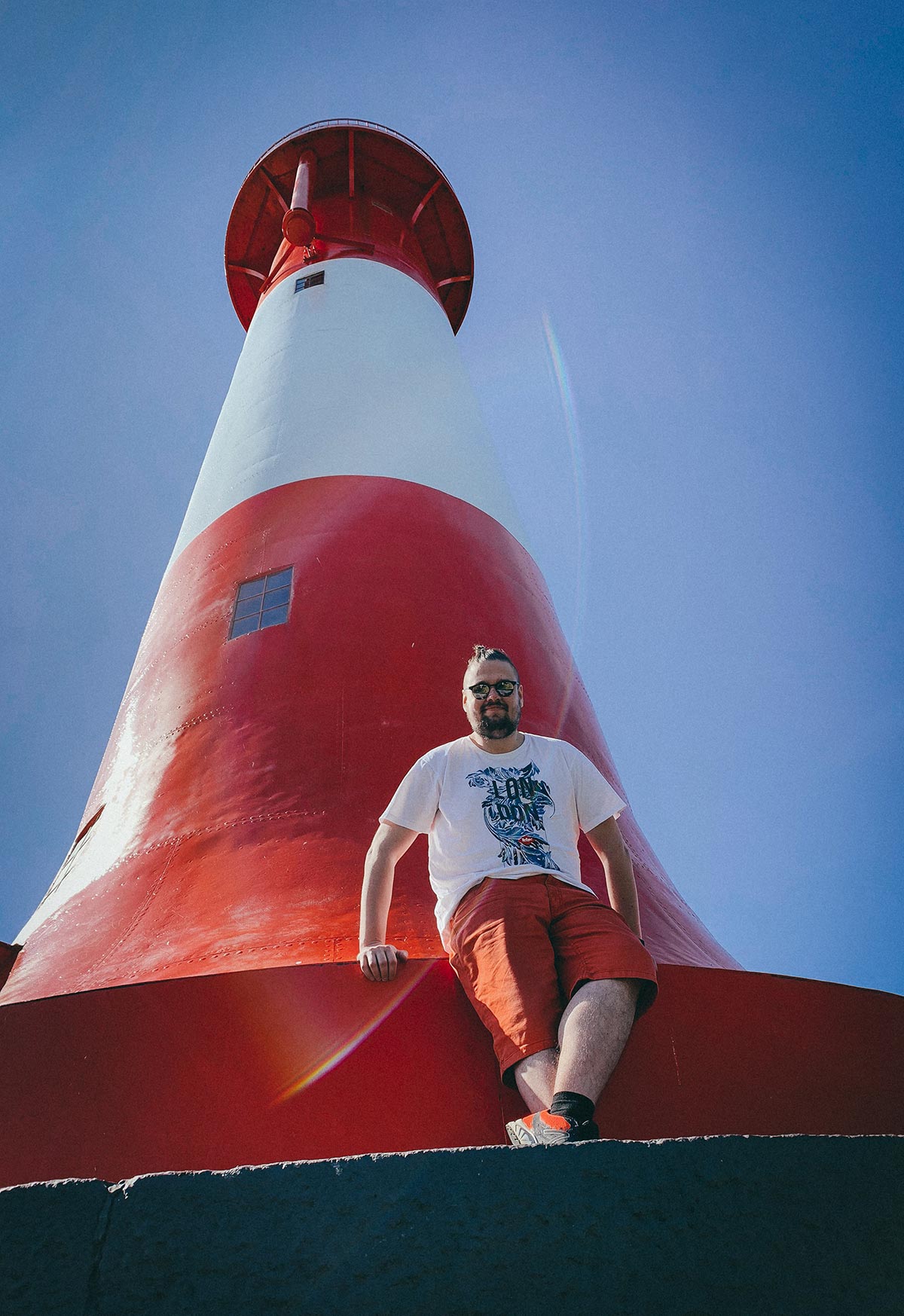 Ari on front of lighthouse in his home town